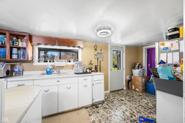 kitchen featuring white cabinetry and sink