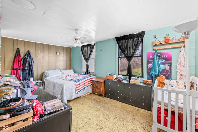 bedroom with ceiling fan and wooden walls