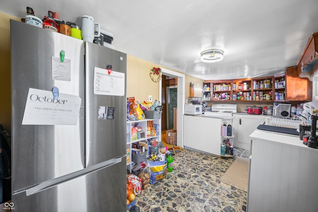 kitchen featuring stainless steel refrigerator and washer / dryer