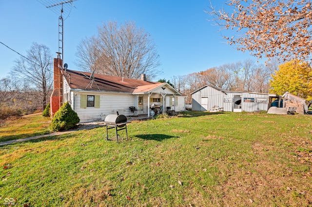 rear view of property with a yard