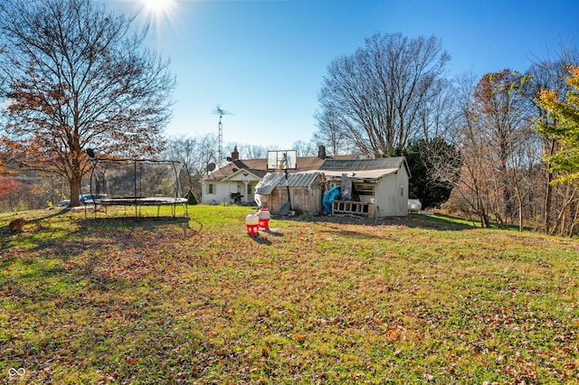 view of yard featuring an outbuilding and a trampoline