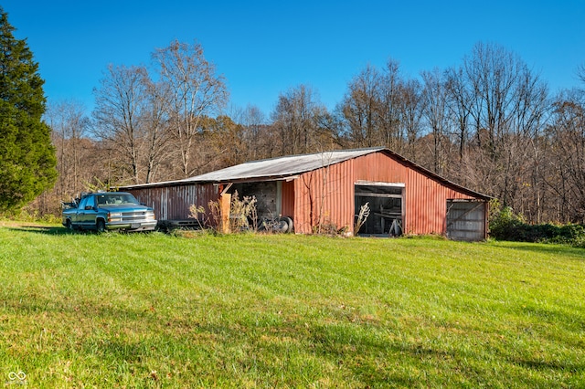 view of outbuilding featuring a yard