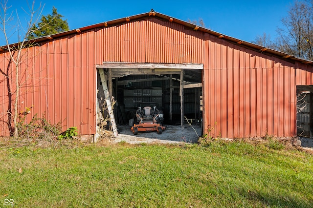 view of outbuilding featuring a lawn