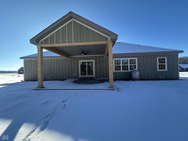 snow covered property featuring ceiling fan