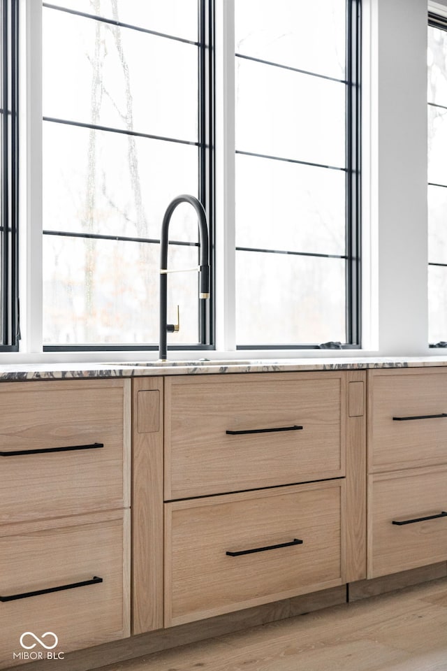 room details featuring light brown cabinetry and light wood-type flooring