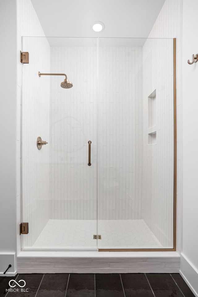 bathroom featuring tile patterned floors and a shower with shower door