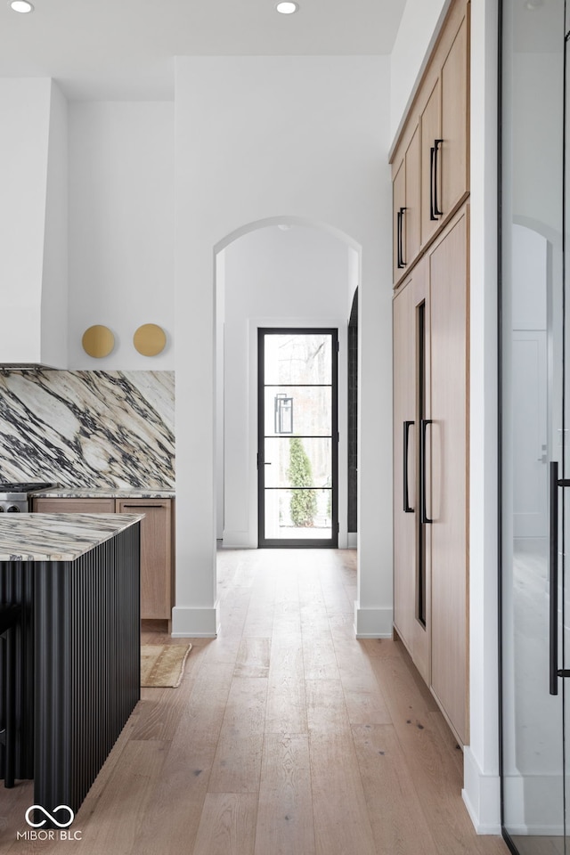 corridor with light hardwood / wood-style floors