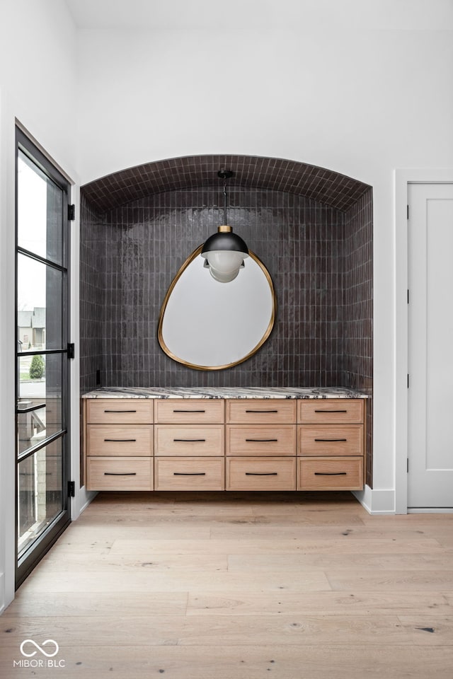 bathroom featuring backsplash, hardwood / wood-style floors, and vanity