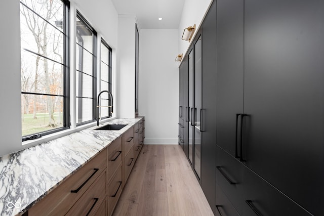 spacious closet featuring light hardwood / wood-style flooring and sink