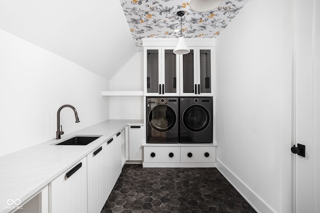 washroom featuring washer and clothes dryer, cabinets, and sink