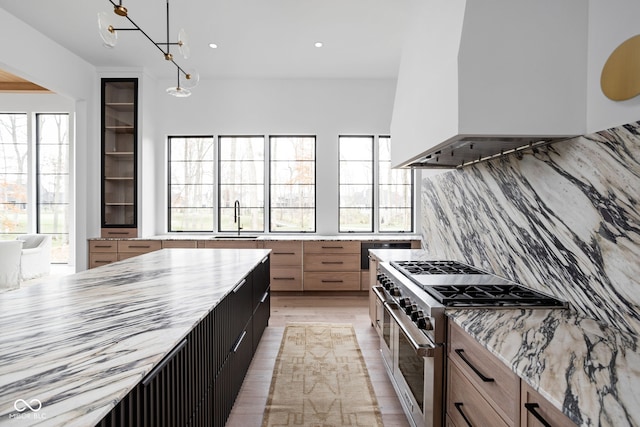 kitchen featuring plenty of natural light, double oven range, and decorative light fixtures