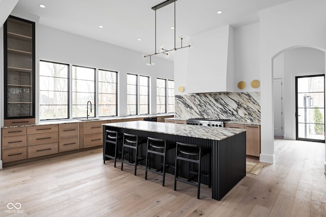 kitchen featuring a healthy amount of sunlight and a breakfast bar area