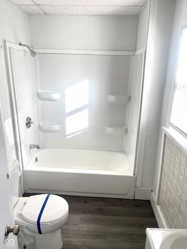 bathroom featuring toilet, shower / tub combination, and hardwood / wood-style flooring