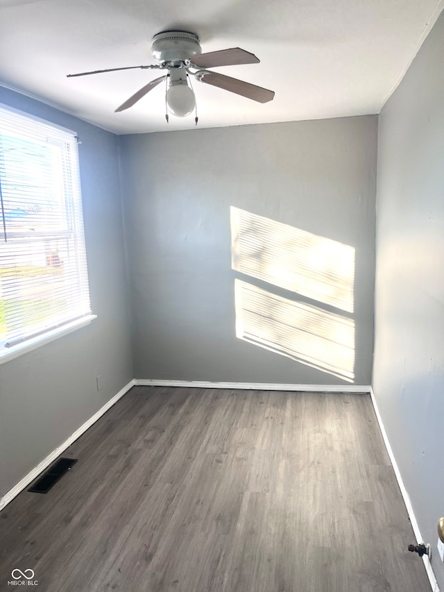 unfurnished room featuring ceiling fan and dark hardwood / wood-style floors