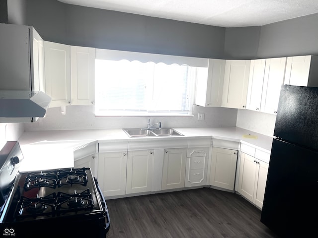 kitchen featuring white cabinets, sink, black appliances, and dark hardwood / wood-style flooring