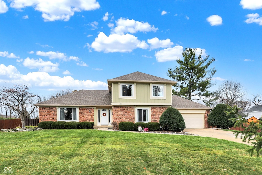 view of front of home with a front yard and a garage