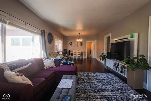 living room featuring dark wood-type flooring and a chandelier