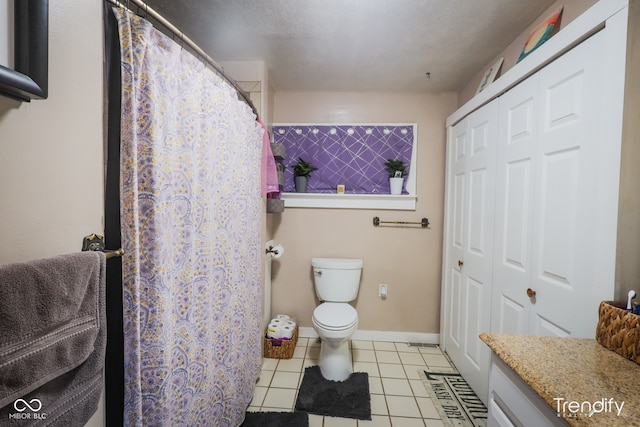 bathroom featuring tile patterned flooring, vanity, and toilet