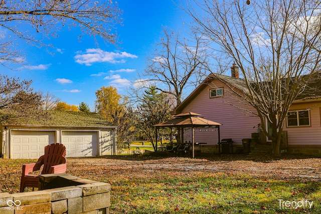 view of yard featuring a garage and a gazebo