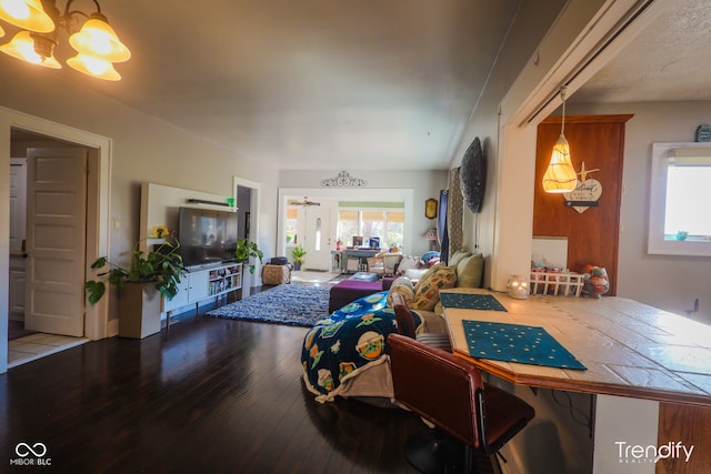 living room with an inviting chandelier and hardwood / wood-style flooring