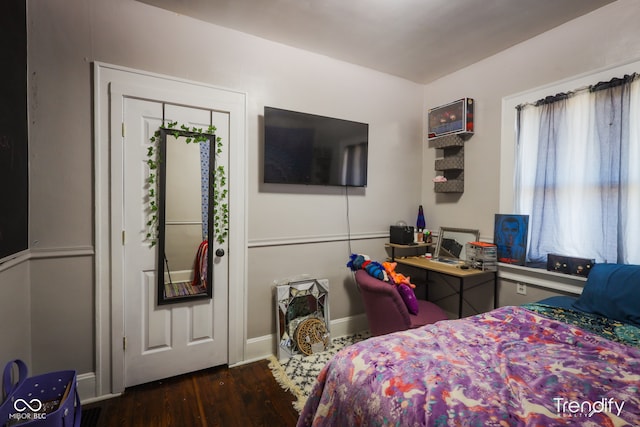 bedroom with dark hardwood / wood-style flooring and a closet