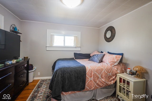 bedroom featuring hardwood / wood-style floors and crown molding