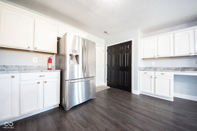 kitchen with white cabinets and stainless steel fridge