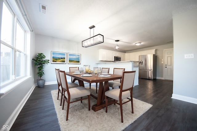 dining area with dark hardwood / wood-style flooring