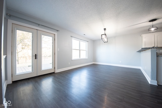 unfurnished dining area with french doors, dark hardwood / wood-style flooring, and a healthy amount of sunlight