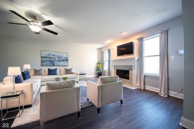 living room with a fireplace, ceiling fan, a textured ceiling, and dark hardwood / wood-style flooring