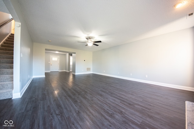 unfurnished living room with dark hardwood / wood-style flooring, a textured ceiling, and ceiling fan