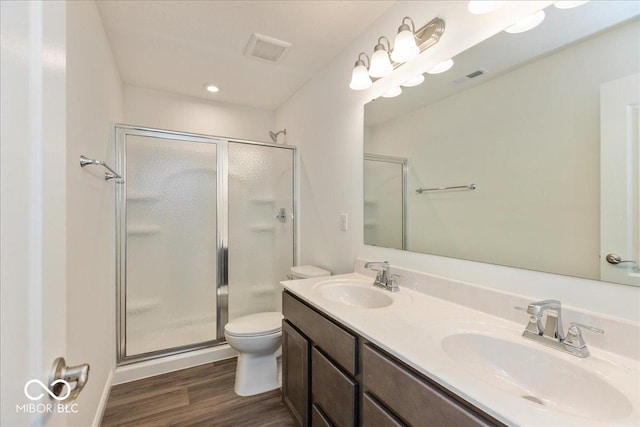 1105 Gatewick Ct, Greenwood, IN 46143 - full bathroom featuring wood finished floors, a shower stall, toilet, and double vanity