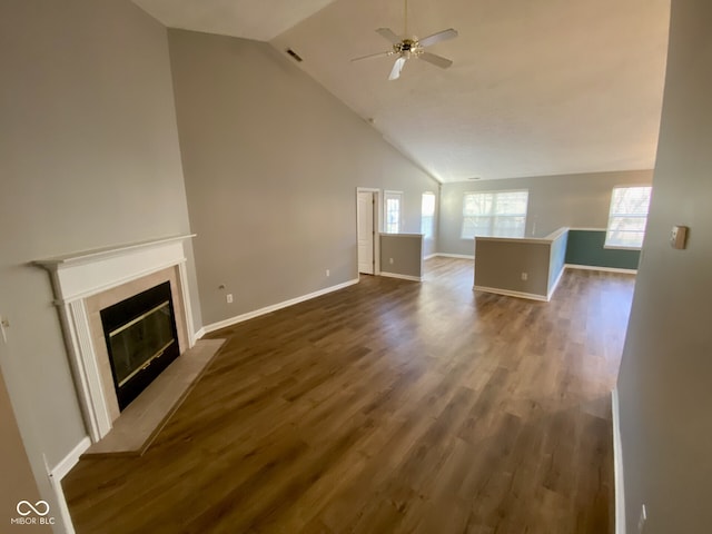 unfurnished living room featuring high vaulted ceiling, dark wood-type flooring, and ceiling fan