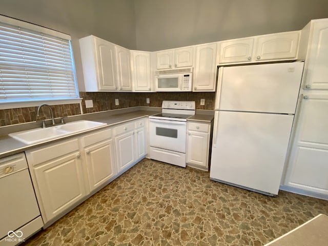 kitchen featuring tasteful backsplash, white cabinetry, white appliances, and sink