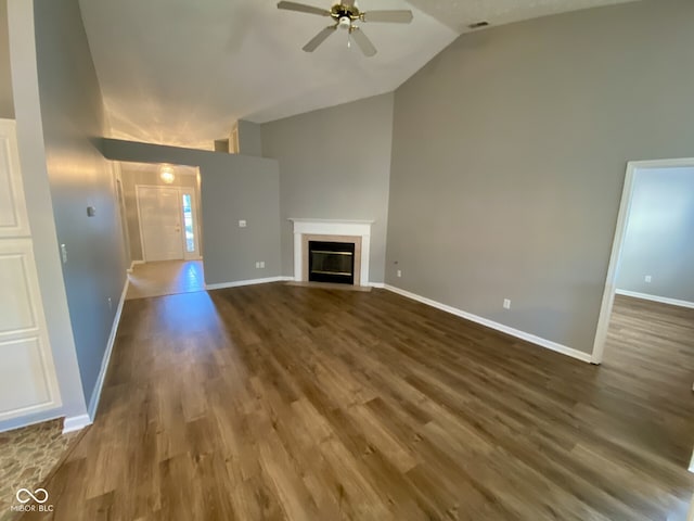 unfurnished living room with lofted ceiling, wood-type flooring, and ceiling fan