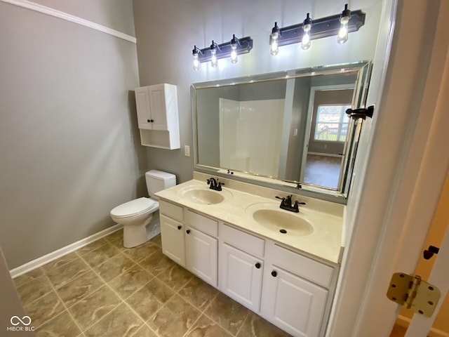 bathroom with toilet, a shower, and vanity