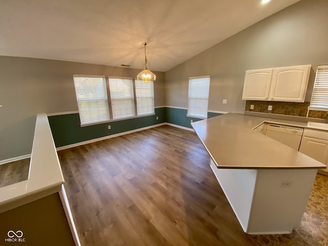 kitchen with white cabinets, white dishwasher, decorative light fixtures, and vaulted ceiling