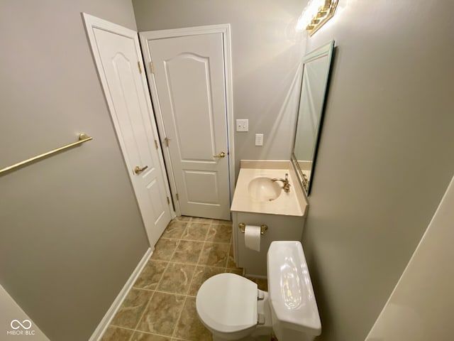 bathroom featuring tile patterned floors, vanity, and toilet