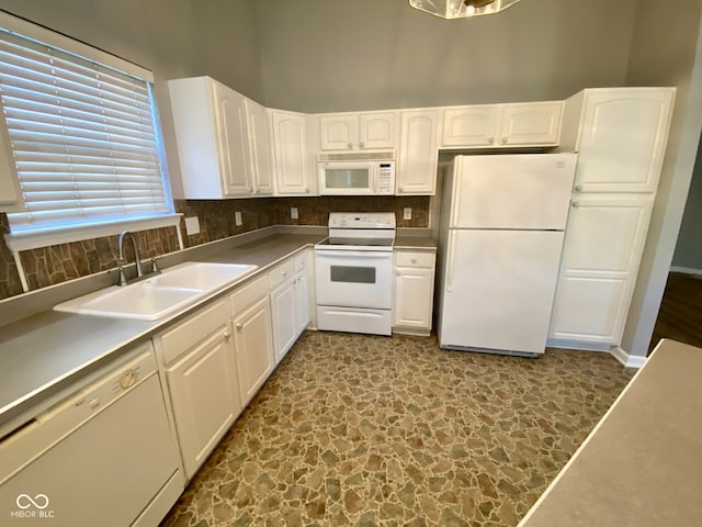 kitchen featuring white cabinetry, decorative backsplash, sink, and white appliances