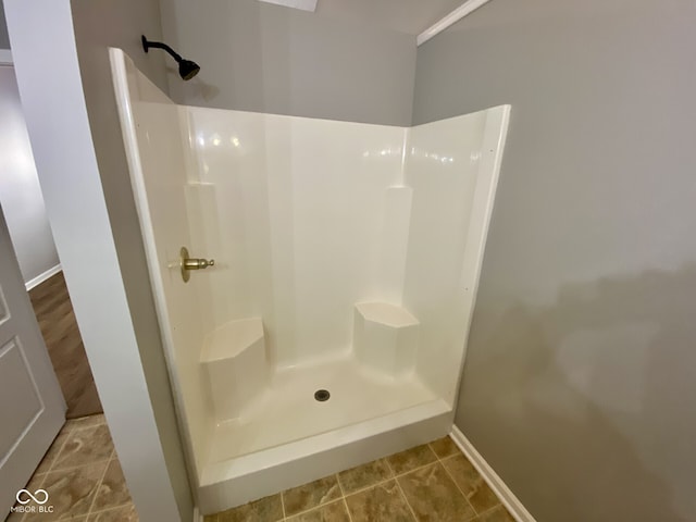 bathroom with a shower and tile patterned flooring