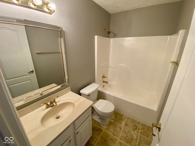 full bathroom featuring a textured ceiling, vanity, shower / bathing tub combination, tile patterned floors, and toilet