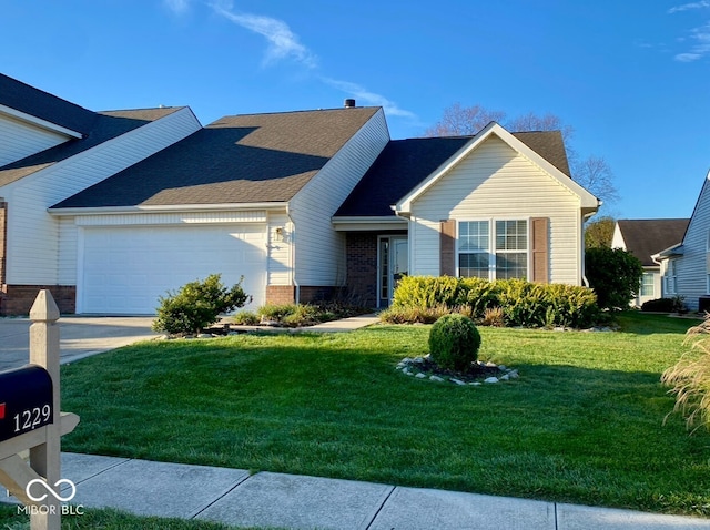 view of front of house with a garage and a front lawn