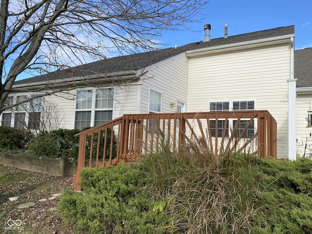 rear view of house featuring a wooden deck