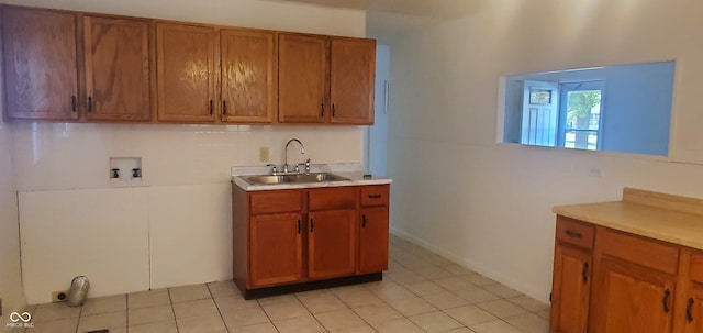 kitchen with sink and light tile patterned flooring