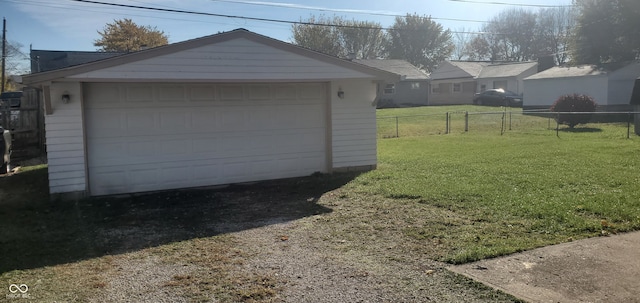 garage featuring a lawn