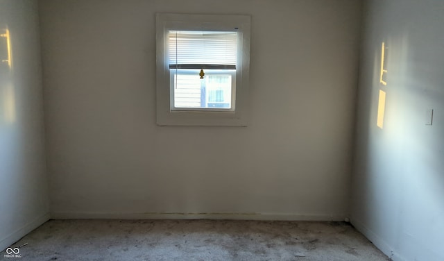 unfurnished room featuring light carpet