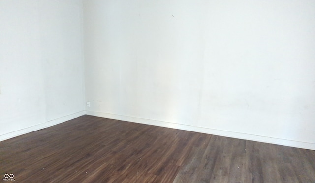 unfurnished room featuring dark hardwood / wood-style flooring