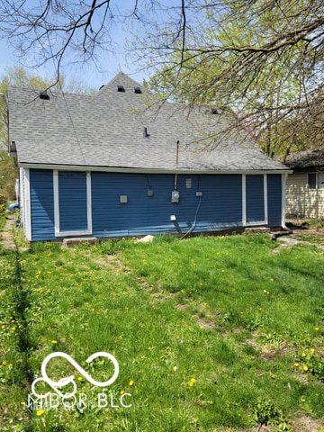 view of side of home with a yard