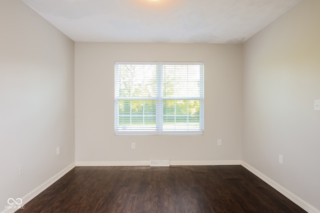 spare room with dark hardwood / wood-style floors