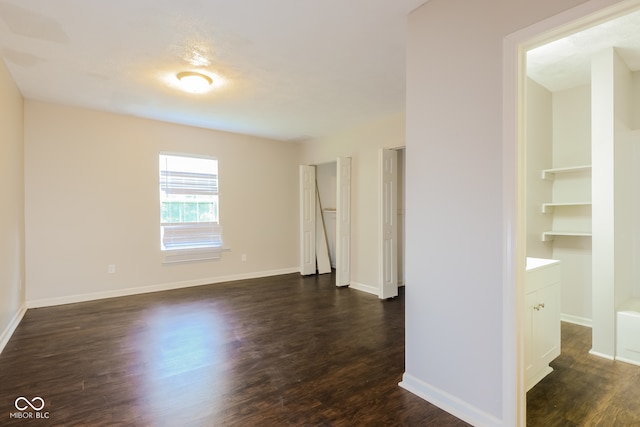 unfurnished room featuring dark hardwood / wood-style floors